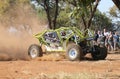 Neon green car kicking up dust during speed timed trial event